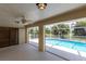 Relax on the lanai featuring a ceiling fan and views of the refreshing pool surrounded by lush tropical foliage at 1612 Blue Lake Cir, Punta Gorda, FL 33983