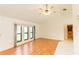 Spacious living room featuring wood floors, a ceiling fan, and three large windows for lots of natural light at 1612 Blue Lake Cir, Punta Gorda, FL 33983