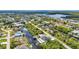 Stunning aerial view of a waterfront neighborhood featuring canals, lush greenery, and a glimpse of the ocean in the distance at 17368 Skipper Ln, Port Charlotte, FL 33948
