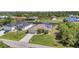 This aerial view of a single Gathering home shows a well-manicured lawn and mature landscaping at 17368 Skipper Ln, Port Charlotte, FL 33948