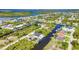 Expansive aerial view featuring waterfront homes, private boat docks, and beautiful tree coverage at 17368 Skipper Ln, Port Charlotte, FL 33948