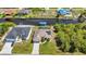 An aerial view captures a home on the water, complete with a private dock and lush foliage at 17368 Skipper Ln, Port Charlotte, FL 33948