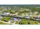 Panoramic aerial view reveals a scenic community along a waterway, surrounded by lush greenery and mature trees at 17368 Skipper Ln, Port Charlotte, FL 33948