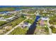 Picturesque aerial view of canal-front homes, boat docks, and lush greenery in a desirable residential area at 17368 Skipper Ln, Port Charlotte, FL 33948