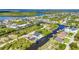 Lovely aerial view showing a neighborhood with waterfront homes, boat docks, canals and manicured landscaping at 17368 Skipper Ln, Port Charlotte, FL 33948