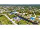 Aerial view reveals a wide waterway winding through a lush community with verdant landscaping and established trees at 17368 Skipper Ln, Port Charlotte, FL 33948