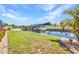 Well-manicured backyard boasts a boat lift on the canal, blending relaxation and waterfront living at 17368 Skipper Ln, Port Charlotte, FL 33948