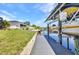 Waterfront backyard with a private dock, offering access to the water and outdoor space at 17368 Skipper Ln, Port Charlotte, FL 33948