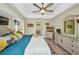 Comfortable bedroom featuring a ceiling fan, tray ceilings, and tile flooring at 17368 Skipper Ln, Port Charlotte, FL 33948
