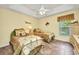 Spare bedroom featuring twin beds, a ceiling fan, and natural light from a window at 17368 Skipper Ln, Port Charlotte, FL 33948