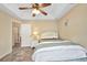 Bright secondary bedroom with a ceiling fan, neutral paint, and adjacent bathroom access at 17368 Skipper Ln, Port Charlotte, FL 33948