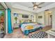 Bright bedroom featuring tray ceilings, ceiling fan and sliding glass doors at 17368 Skipper Ln, Port Charlotte, FL 33948