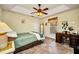 A simple guest bedroom with a ceiling fan, light yellow walls, and a window that provides lots of natural light at 17368 Skipper Ln, Port Charlotte, FL 33948