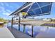 Boat on a lift at a private covered dock, providing waterfront living and boat storage at 17368 Skipper Ln, Port Charlotte, FL 33948