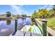 Private dock with kayaks, providing direct access to the canal and recreational opportunities at 17368 Skipper Ln, Port Charlotte, FL 33948