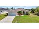 Charming home with a metal roof, a well-manicured lawn and mature tropical landscaping at 17368 Skipper Ln, Port Charlotte, FL 33948