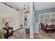 Inviting foyer features a decorative light fixture, and a view of the sitting room at 17368 Skipper Ln, Port Charlotte, FL 33948