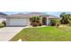 Well-maintained front yard with lush landscaping and a charming single-story home at 17368 Skipper Ln, Port Charlotte, FL 33948