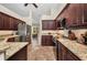 Well-equipped kitchen featuring stainless steel appliances, granite countertops, and dark wood cabinetry at 17368 Skipper Ln, Port Charlotte, FL 33948