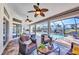 Comfortable screened lanai with brick flooring, ceiling fans, and outdoor furniture overlooking the pool and waterfront at 17368 Skipper Ln, Port Charlotte, FL 33948