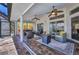 Covered lanai offers a cozy seating area, ceiling fans, and seamless access to the outdoors at 17368 Skipper Ln, Port Charlotte, FL 33948