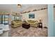 Spacious living room with tile flooring, ceiling fan, and sliding doors to the pool at 17368 Skipper Ln, Port Charlotte, FL 33948