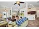 Open concept living room with tile flooring, view to the foyer, sitting room, and kitchen at 17368 Skipper Ln, Port Charlotte, FL 33948