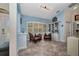 Sitting room with decorative shelving, shutters, two leather chairs and tile flooring at 17368 Skipper Ln, Port Charlotte, FL 33948
