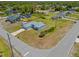 An aerial view of a light blue single-Gathering home surrounded by lush greenery and neighboring houses at 1981 Arena Ln, North Port, FL 34286