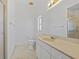 Bright bathroom featuring a single sink vanity, shower, and toilet at 1981 Arena Ln, North Port, FL 34286