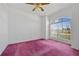 Bedroom with pink carpet, arched window, and white walls at 1981 Arena Ln, North Port, FL 34286