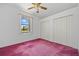 Pink carpeted bedroom with a window, closet, and ceiling fan at 1981 Arena Ln, North Port, FL 34286