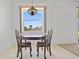 Cozy dining area with a view of the backyard, pendant lighting and neutral-colored flooring at 1981 Arena Ln, North Port, FL 34286
