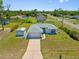 Charming single-story home with a well-maintained lawn, two car garage, and a separate storage shed at 1981 Arena Ln, North Port, FL 34286