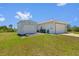 An exterior view of a detached shed attached to a two car garage of a single-Gathering home at 1981 Arena Ln, North Port, FL 34286