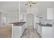 The kitchen has white appliances, ample cabinets, and a breakfast bar at 1981 Arena Ln, North Port, FL 34286