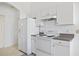 Bright kitchen features white appliances, ample counter space, and plenty of cabinet storage at 1981 Arena Ln, North Port, FL 34286