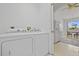 Laundry room with washer and dryer adjacent to the kitchen at 1981 Arena Ln, North Port, FL 34286