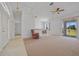 Bright living room featuring a neutral color scheme, ceiling fan, and sliding glass doors to lanai at 1981 Arena Ln, North Port, FL 34286