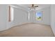 Spacious main bedroom with three windows providing natural light and neutral carpeting at 1981 Arena Ln, North Port, FL 34286
