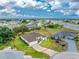 A charming property from an aerial view featuring a manicured lawn, long driveway, and tropical landscaping at 2168 Calcutta Rd, Punta Gorda, FL 33983