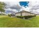 Backyard with hedges and a view of the screened in patio at 2168 Calcutta Rd, Punta Gorda, FL 33983
