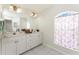Spacious bathroom with double sink vanity, tiled floor, and natural light at 2168 Calcutta Rd, Punta Gorda, FL 33983
