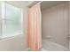 Bathroom featuring a peach color shower curtain and tan tile in the shower at 2168 Calcutta Rd, Punta Gorda, FL 33983