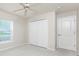 Bright bedroom featuring a ceiling fan, window with blinds, and double closet at 2168 Calcutta Rd, Punta Gorda, FL 33983