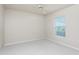 Clean bedroom with plush carpet, fan and a window providing natural light at 2168 Calcutta Rd, Punta Gorda, FL 33983