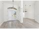Bright foyer with cathedral ceilings, modern gray flooring, and elegant hanging light fixtures at 2168 Calcutta Rd, Punta Gorda, FL 33983