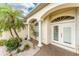 Close up of the columned entrance with a double door, with manicured plants and decorative gravel at 2168 Calcutta Rd, Punta Gorda, FL 33983