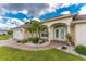 Inviting entrance featuring white columns, complemented by manicured landscaping with tropical plants and white gravel accents at 2168 Calcutta Rd, Punta Gorda, FL 33983