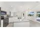 Well-equipped kitchen with stainless steel appliances and an island, seamlessly connected to the outdoor area at 2168 Calcutta Rd, Punta Gorda, FL 33983